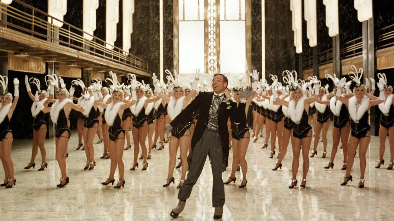 Steve Martin dancing with rows of  female dancers